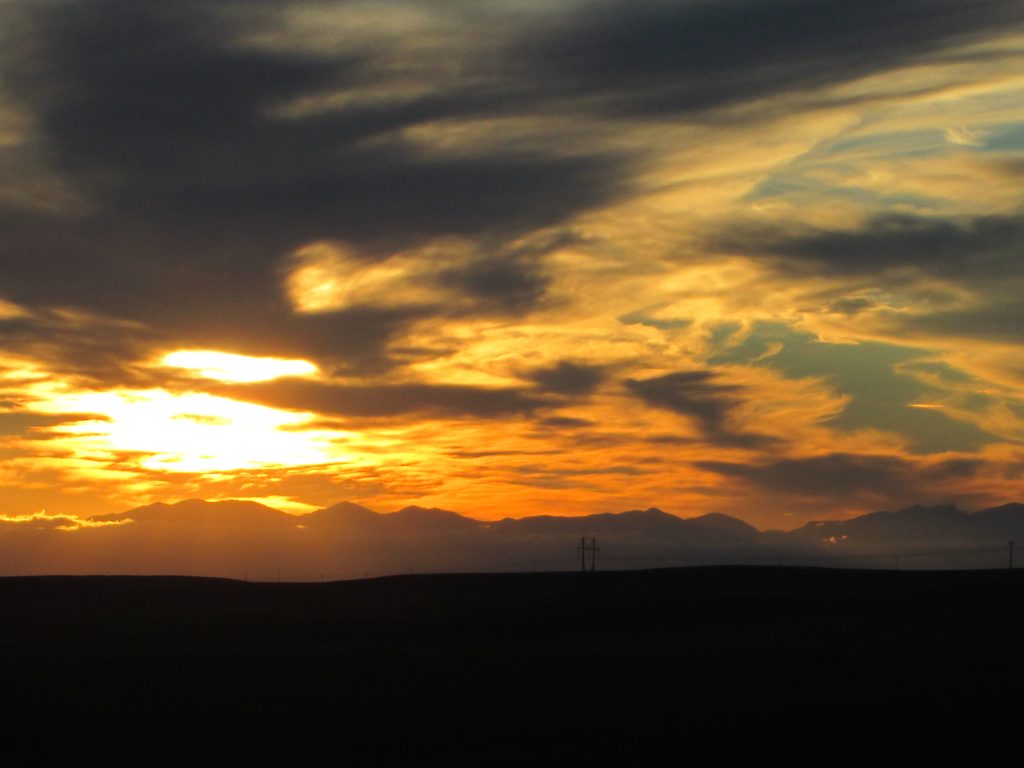 A surreal sunset over the Bighorn Mountains of Wyoming, illustrating the author's love of both travel and photography.