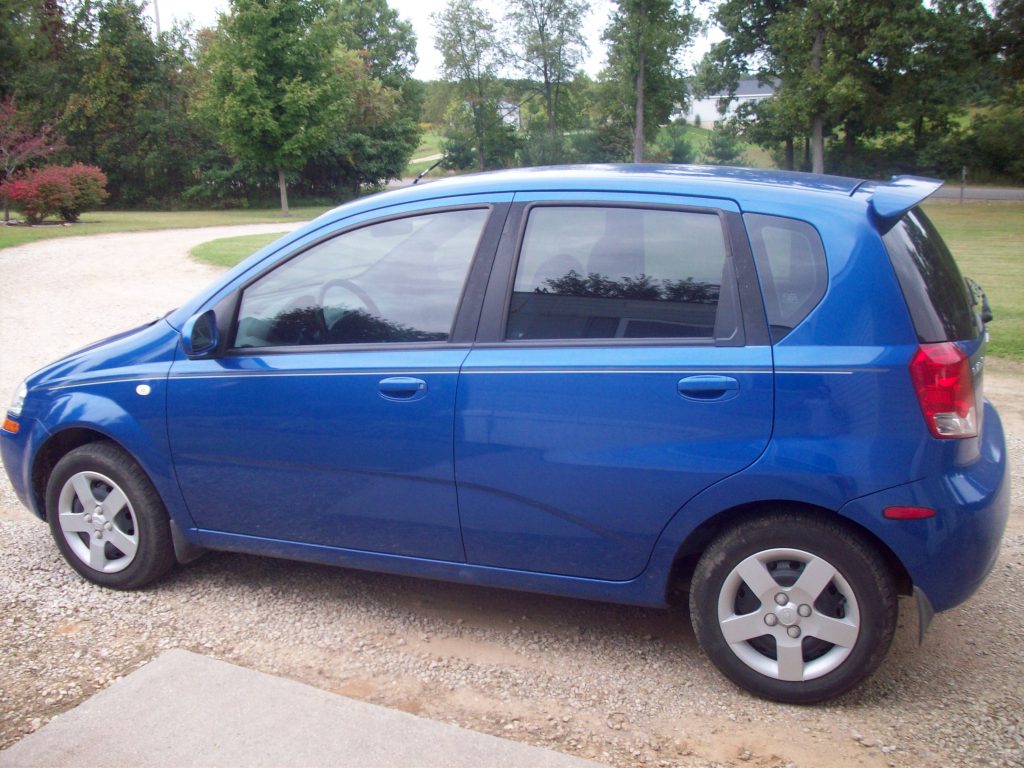 Blue Chevy Aveo hatchback in nice condition, a vehicle upgrade for the author and his wife.