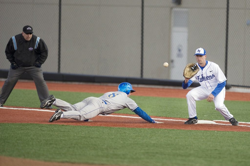 A baseball infielder in perfect position to make a play on a diving base-runner, illustrating the typical results of a budgeting system which revolves around your savings goals.