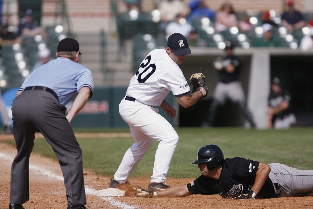 A baseball infielder out of position to make a play on a diving base-runner, illustrating the non-optimal results of typical budgeting systems.