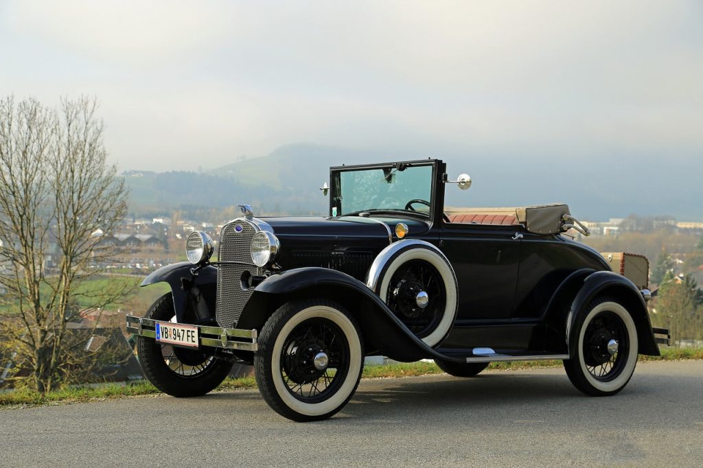 A 1930's-era classic car with a fender-mounted spare tire, illustrating a design feature that correlates to your emergency fund.