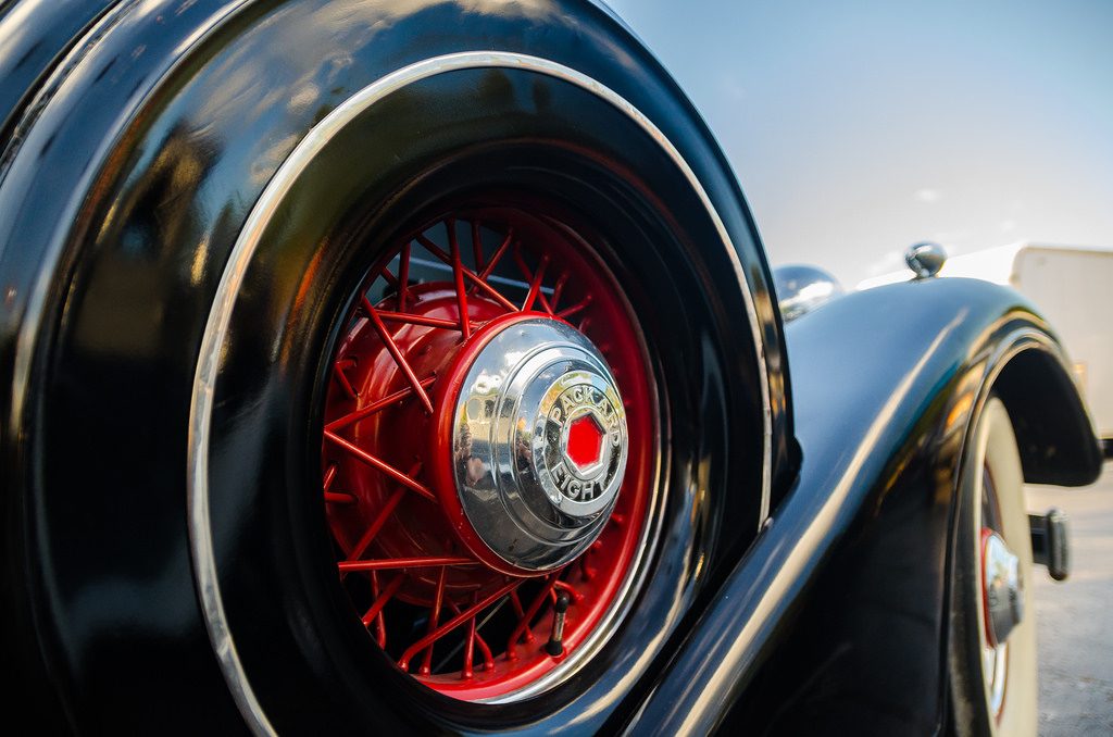 A close-up of a fender-mounted spare tire on a classic Packard roadster, illustrating the need to prepare for emergency on your financial freedom road trip.