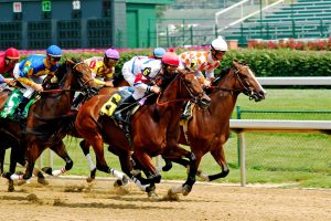 Two racehorses neck-and-neck on the track, illustrating the tight race between the Debt Snowball and the Debt Avalanche to be first to the debt-free finish line.