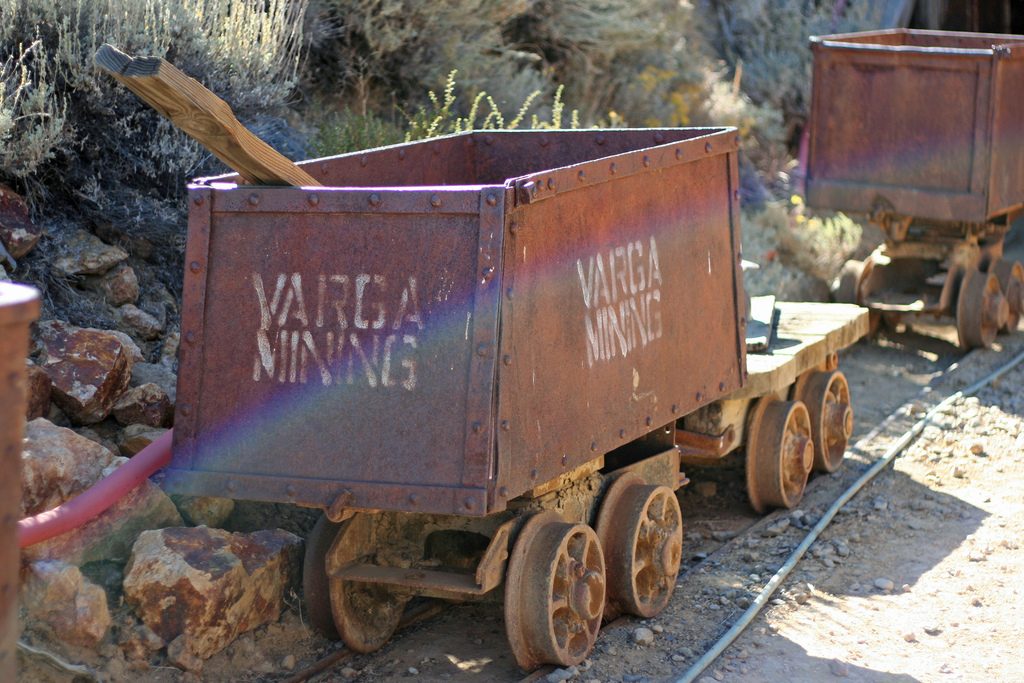 A mining cart on rails, illustrating the potential wealth made possible by mining your debt with extra payments.