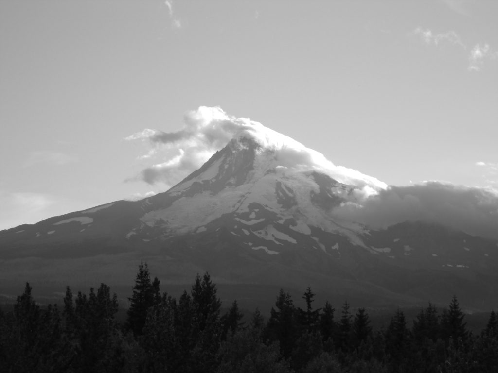 Clouds spilling over the peak of Oregon's Mt. Hood.