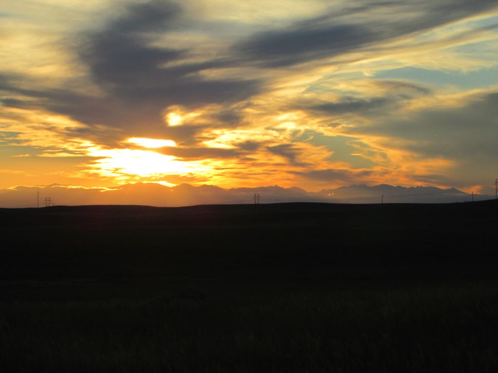 Sunrays highlighting Wyoming's Bighorn Mountain range off in the distance.