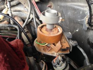A rusty distributor in need of replacement.
