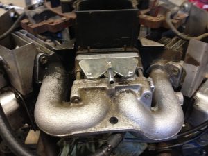 Carburetor in place on lawn tractor engine.